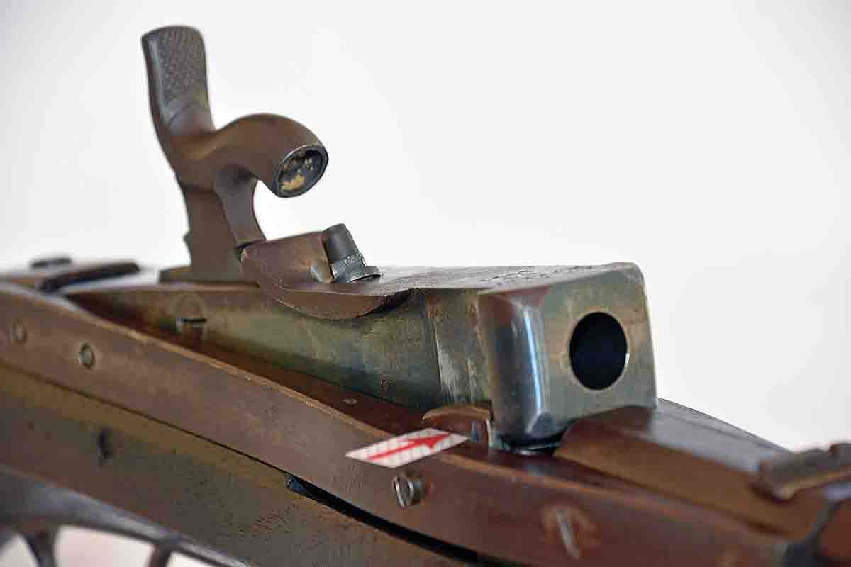 The breechblock of the Hall rifle raised for loading. After dropping the powder and a roundball into the chamber, just push the breechblock down until it locks into place. Put a cap on the nipple and it is ready to fire. The red arrow points to a “chock.”